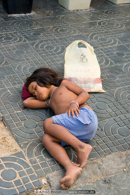 17 Child sleeping on the pavement