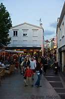 06 Tourists in alley with restaurants and shops