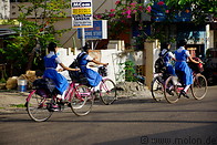 16 Schoolgirls in uniform on bicycles
