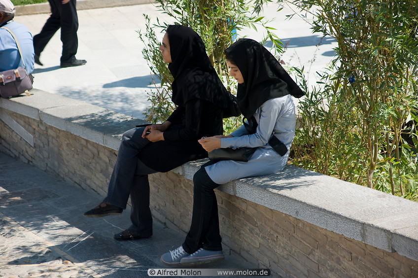 06 Young Iranian women sitting on wall