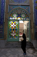 22 Woman walking past mosque portal
