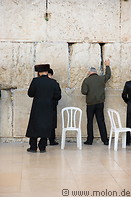 15 Jews praying along wall