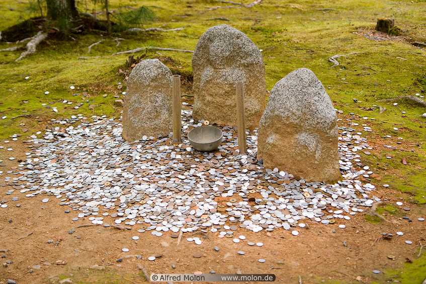 11 Jizo Buddhist images and coins thrown by visitors
