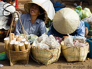 28 Ladies with straw hats selling rice snacks