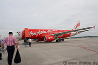 11 Travellers boarding red AirAsia jet