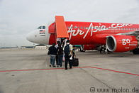 12 Travellers boarding red AirAsia jet