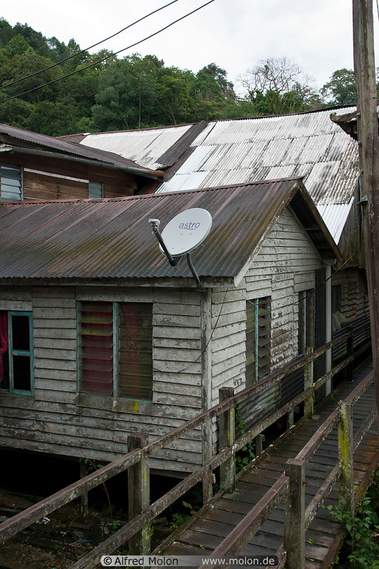 10 Houses with corrugated tin roofs and satellite dish