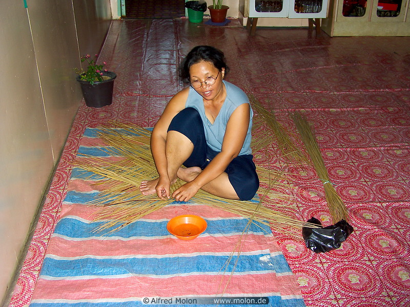 21 Kayan woman weaving a mat