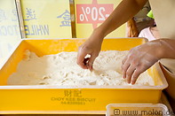 04 Woman preparing peanuts sweets