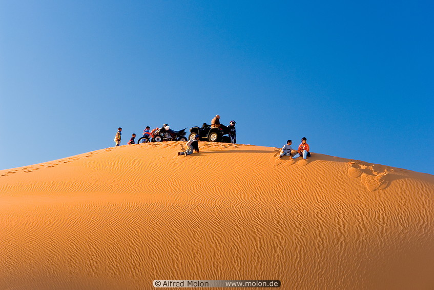 34 Tourists waiting for sunset on sand dune