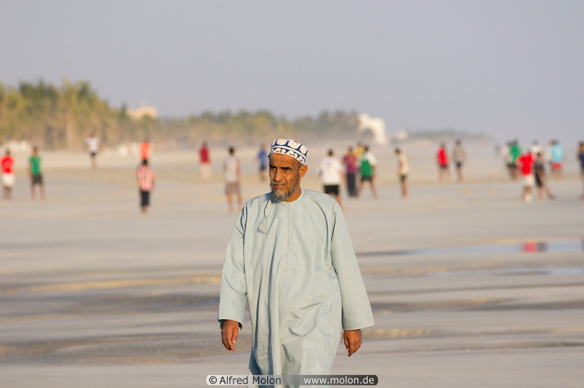 10 Omani man walking on beach