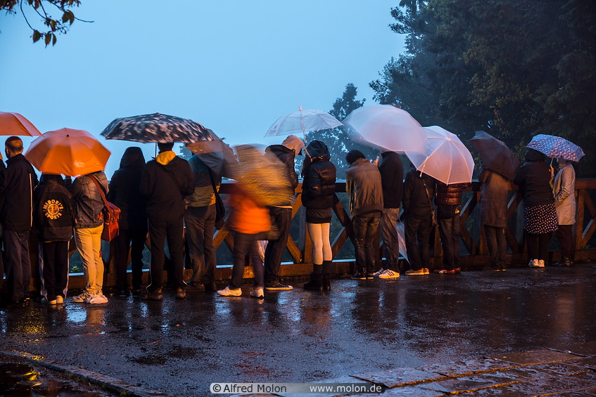 15 Tourists waiting for the sunrise in the rain