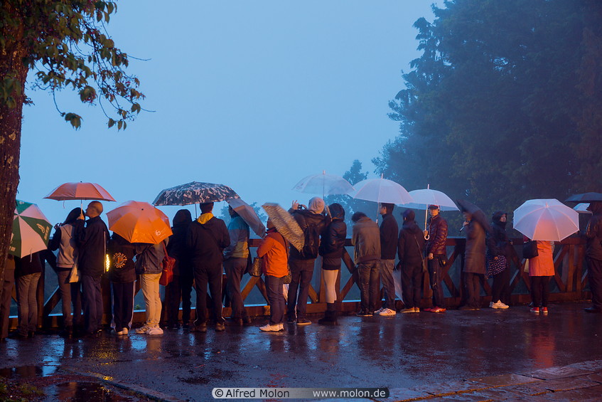 16 Tourists waiting for the sunrise in the rain