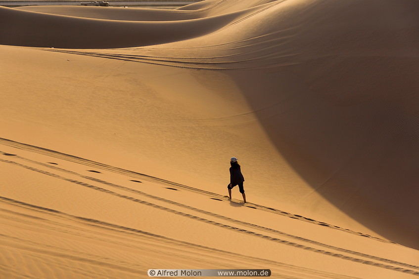 05 Girl walking on sand dunes
