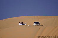 12 Emiratis resting with 4WD car