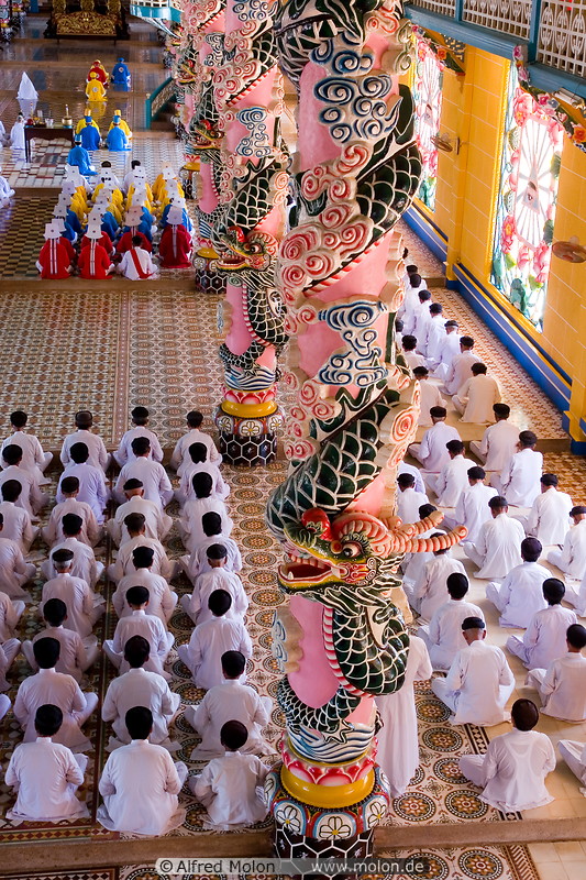15 Cao Dai worshippers and ornamental columns